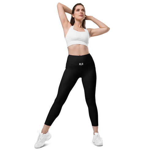 Athlete modeling black RLR Hybrid Pocket Leggings in an active pose
